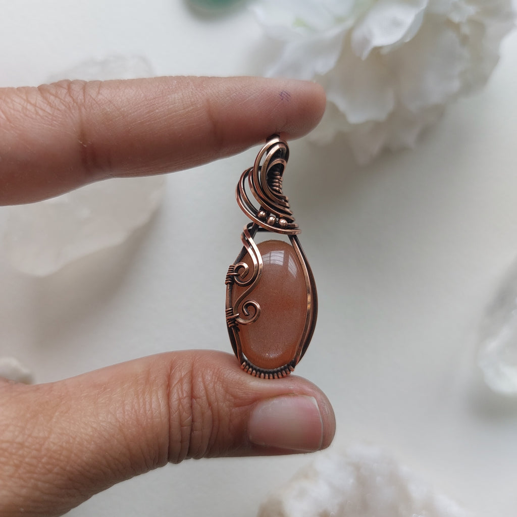 Peach moonstone with sunstone inclusions- wire wrapped copper handmade crystal pendant