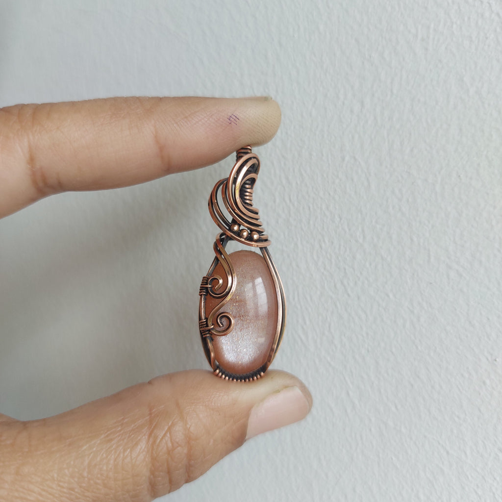 Peach moonstone with sunstone inclusions- wire wrapped copper handmade crystal pendant